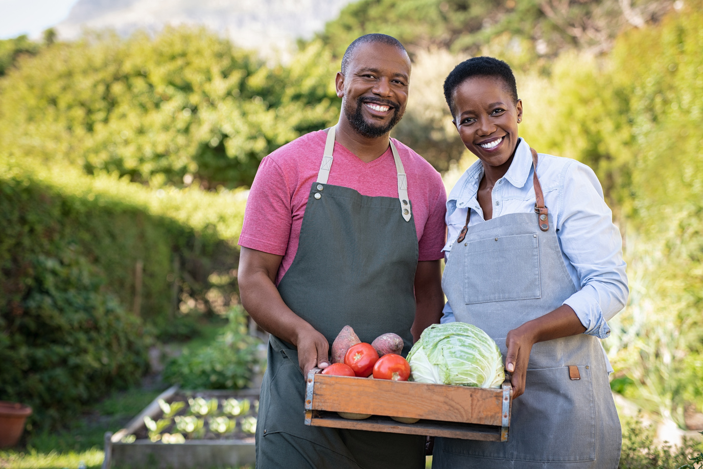 Farmer Couple Holding Vegetable Crate